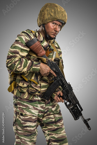 Male in uniform conforms to Russian army special forces (OMON) in War in Chechnya. Isolated on grey background