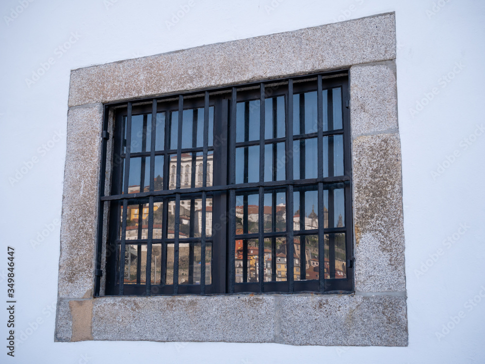 Obraz premium Reflection of the old town of Porto in a window at the Douro River, Porto Portugal.