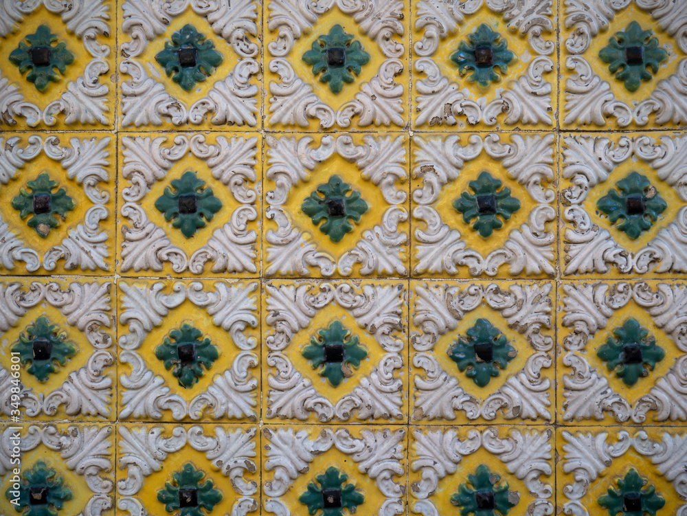 Ornaments on an antique ceramic tile in the old city center of Porto in Portugal. White, Green and Yellow 