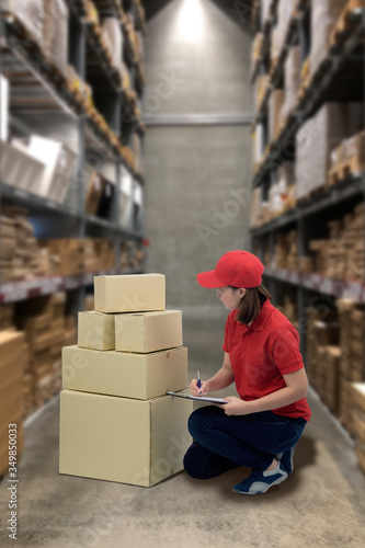 Female staff and parcel boxes checking stock and Blurred the background of the warehouse