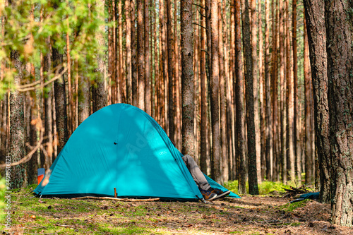hiking travel life style passion concept picture of tent camp side place in forest moody nature environment green foliage and ground with hand made stone trail