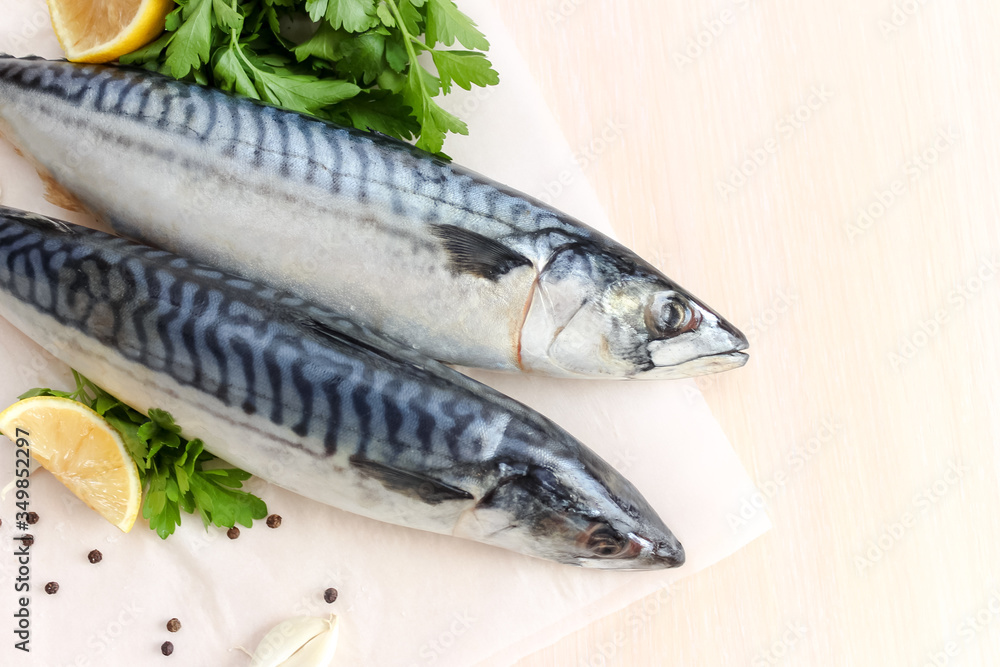 Uncooked Atlantic mackerel with lemon and greens Uncooked Atlantic mackerel with lemon and greens