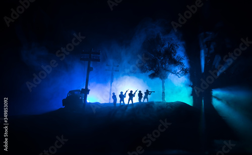 War Concept. Military silhouettes fighting scene on war fog sky background  World War Soldiers Silhouette Below Cloudy Skyline At night.