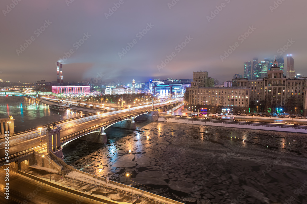 MOSCOW, RUSSIA - 4 JANUARY 2017: Night view to Borodinsky Bridge over the Moskva river, Evropeisky shopping mall and Moscow City international business center on background