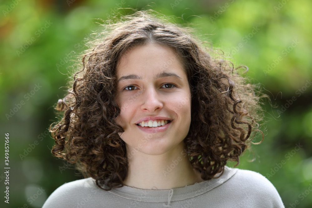 Portrait of a beautiful young brunette girl with curly hair Portrait of a beautiful young brunette girl with curly hair