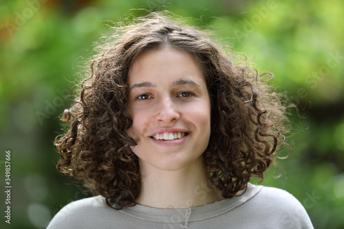 Portrait of a beautiful young brunette girl with curly hair