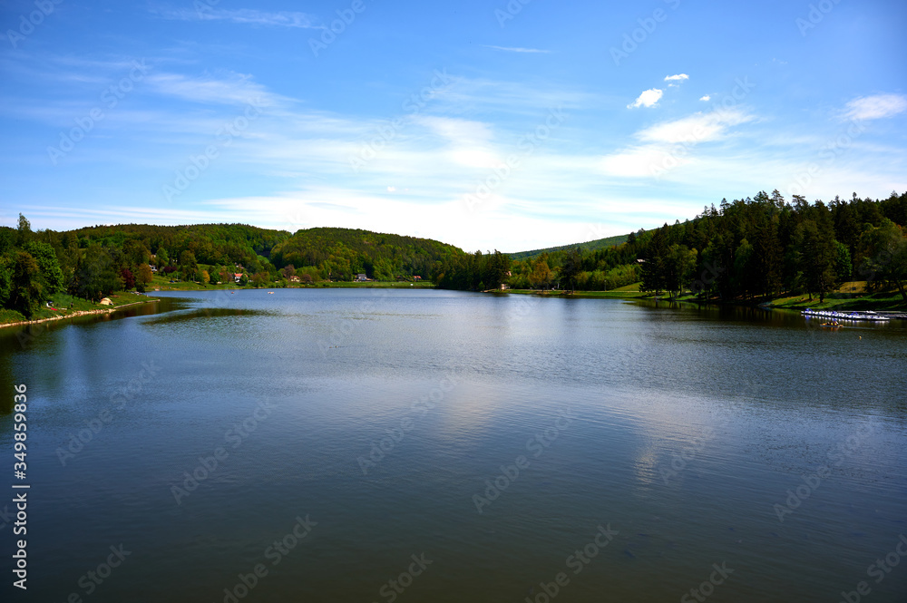 dam in the forest with blue sky