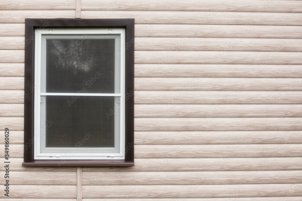 Fototapeta premium Exterior house wall with wood siding and a single window. Copy space. 