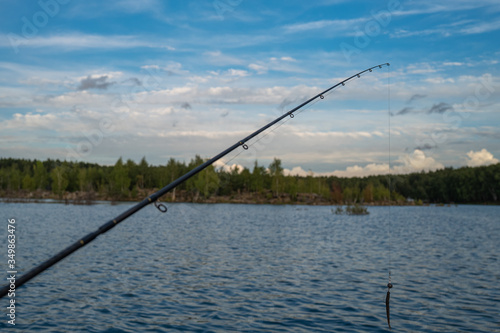 Spinning rod. Fishing on a lake. Summer.
