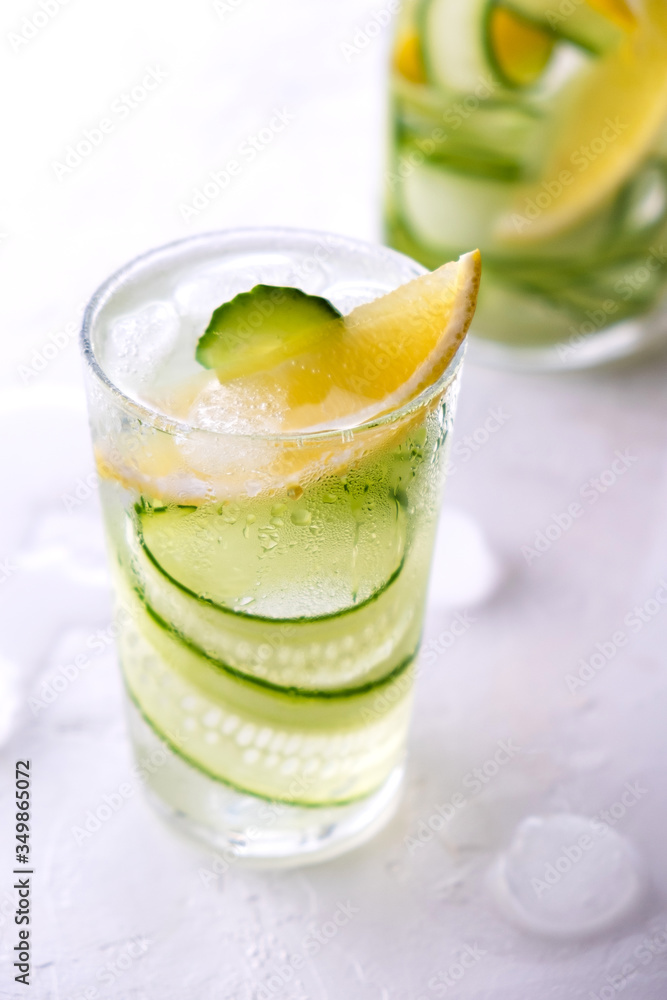Cold and refreshing infused detox water with lemon and cucumber in a glas. Homemade flavored lemonade Cold and refreshing infused detox water with lemon and cucumber in a glas. Homemade flavored lemonade