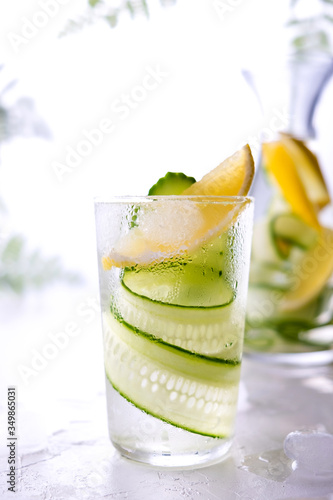 Cold and refreshing infused detox water with lemon and cucumber in a glas. Homemade flavored lemonade