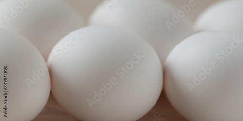 chicken white raw fresh eggs lie on a wooden surface