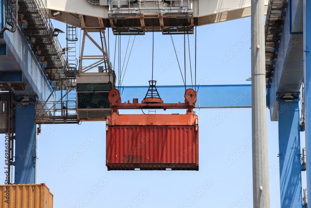 Transtainer crane moving a Shipping Container to a storage platform.
