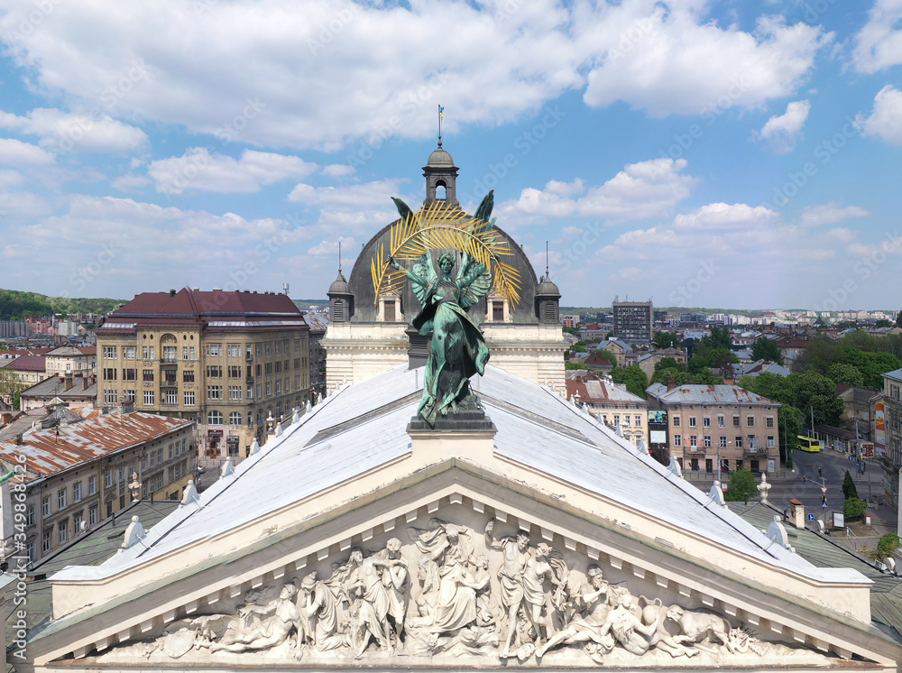 Sculpture of fame with palm branch on Lviv opera house, Ukraine from drone