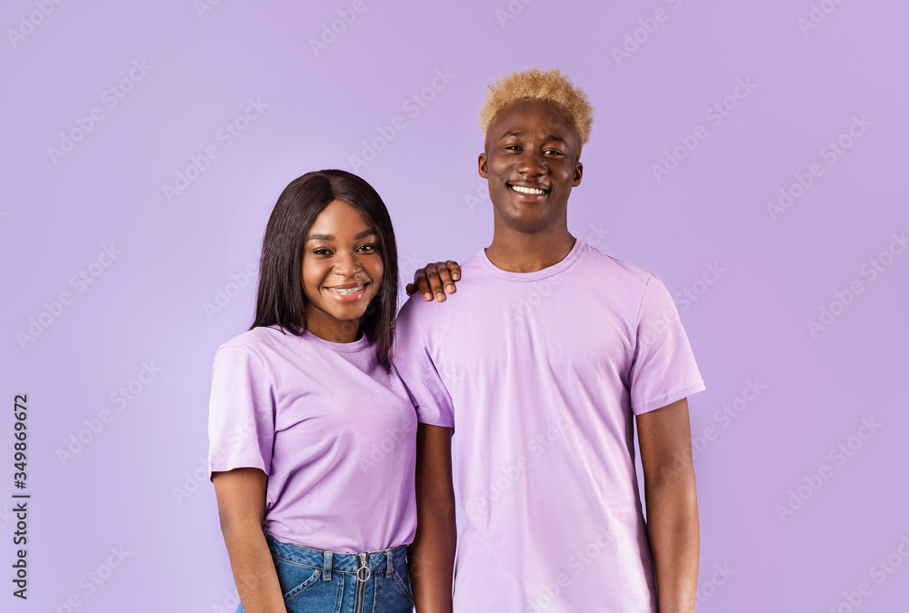 Romantic African American couple smiling on color background Romantic African American couple smiling on color background
