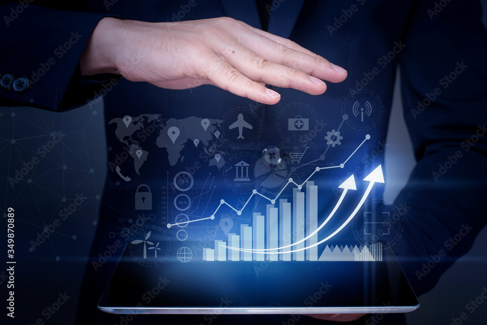 Naklejka premium Businessman is holding financial growth graph and analyzing business data, business plan and strategy concept .