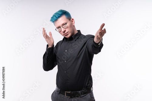Stylish young man with blue hair is beckoning audience to follow him, with a seductive and charming expression, studio, editable background
