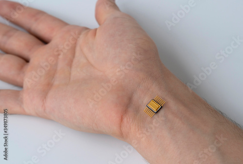 microchip is connected to a man hand. implantation of a chip under the human skin. photo