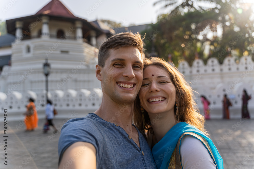 happy couple takes selfie in front of Sri Dalada Maligawa Temple, Kandy, Sri Lanka happy couple takes selfie in front of Sri Dalada Maligawa Temple, Kandy, Sri Lanka