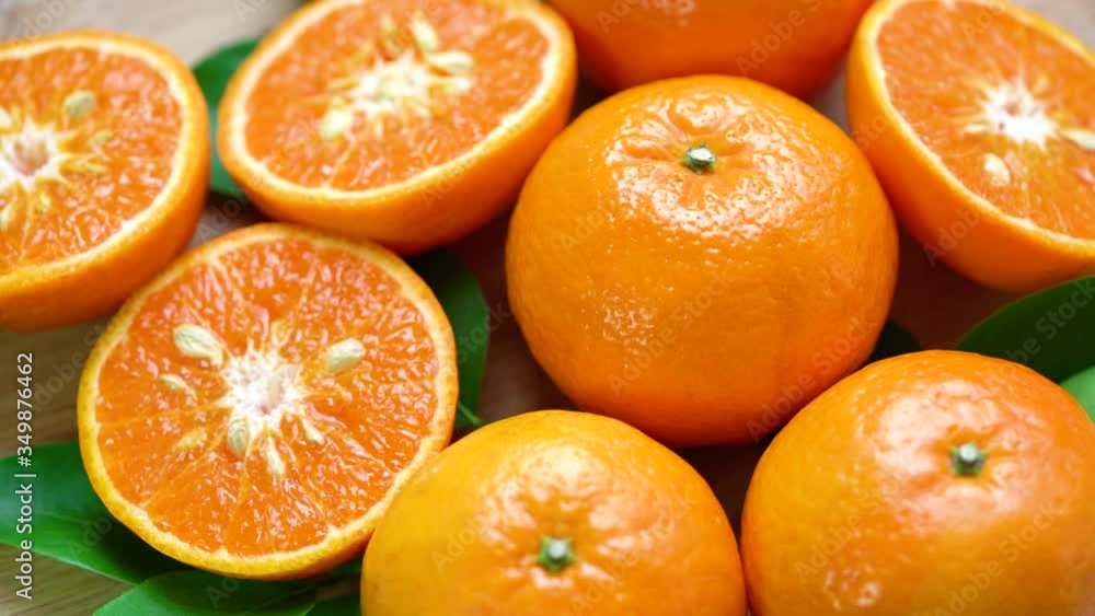 Orange fruit with slices closeup, fruits top view Rotate, Nature orange fruit with green leaves in the garden. Orange fruit with slices closeup, fruits top view Rotate, Nature orange fruit with green leaves in the garden.