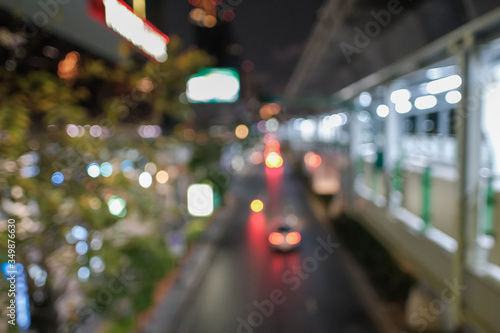 Blurred defocused lights of heavy traffic. Abstract blur image of night light bokeh on street. Blur traffic road with colorful bokeh light. Copy space of transportation and travel concept.