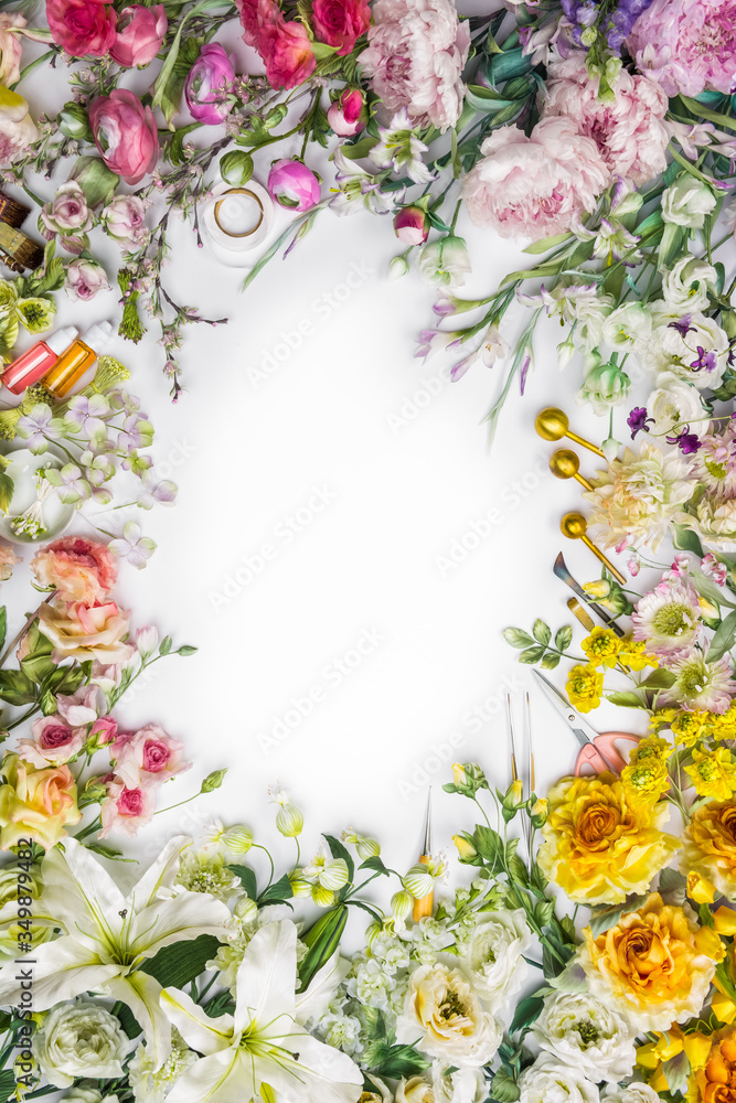 Top view of round frame with decoration artificial flowers, branches, leaves, petals, instruments and paint. isolated on white background.
Top view of round frame with decoration artificial flowers, branches, leaves, petals, instruments and paint. isolated on white background.