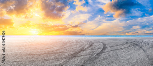 Race track road and lake with sky cloud landscape at sunset.
