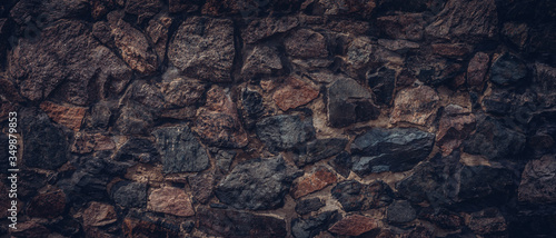 Fotografi Dark brown stone wall texture background