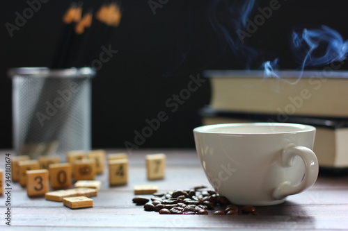 hot coffee on retro wood floor with education accessory isolate on black background