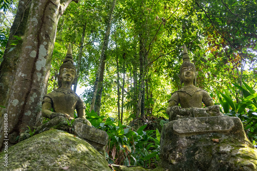 Ancient stone statues in Secret Buddhism Magic Garden  Koh Samui  Thailand. A place for relaxation and meditation. Secret Buddha Garden