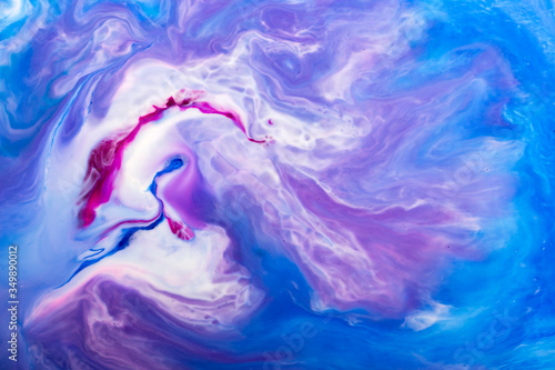 Fluid art- marbled effect. Purple oil paint abstract.