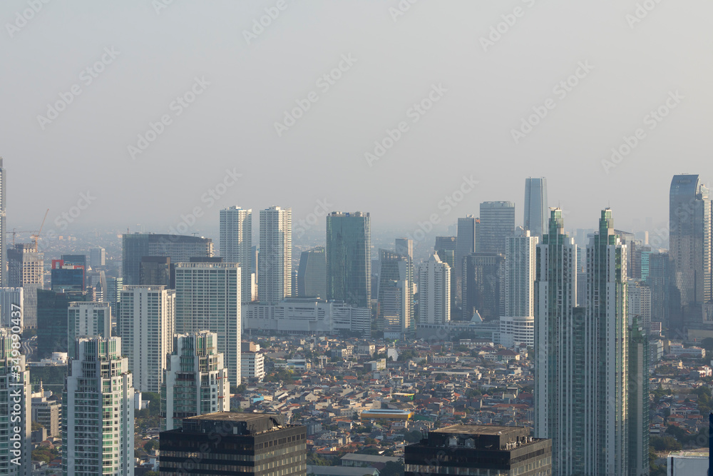 Jakarta, Indonesia - October 20, 2019: General aerial view of the skyline of the city of Jakarta, the capital of Indonesia, Java island, submerged by the dense smoke of pollution and the haze.
