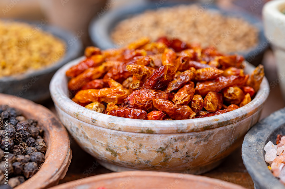 Indian spices collection, dried red hot chili peppers and another spices in clay bowls Indian spices collection, dried red hot chili peppers and another spices in clay bowls