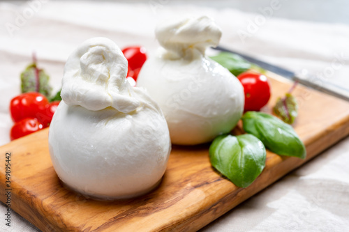Cheese collection, fresh soft white burrata cheese ball made from mozzarella and cream from Apulia, Italy