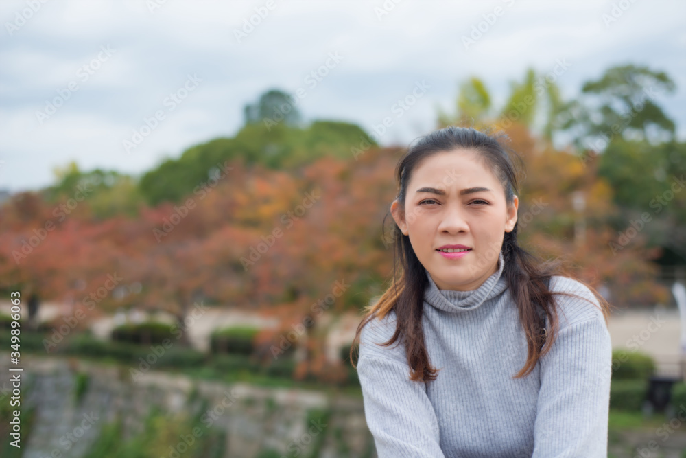 Asian woman in autumn nature background at Osaka park of Japan Asian woman in autumn nature background at Osaka park of Japan