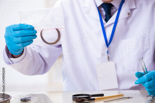 Old male expert criminologist working in the lab for evidence