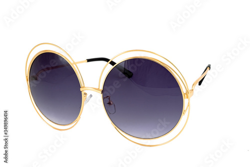 Round sunglasses with night blue gradient lenses and gold colored wrap around frames isolated on white background, side view.