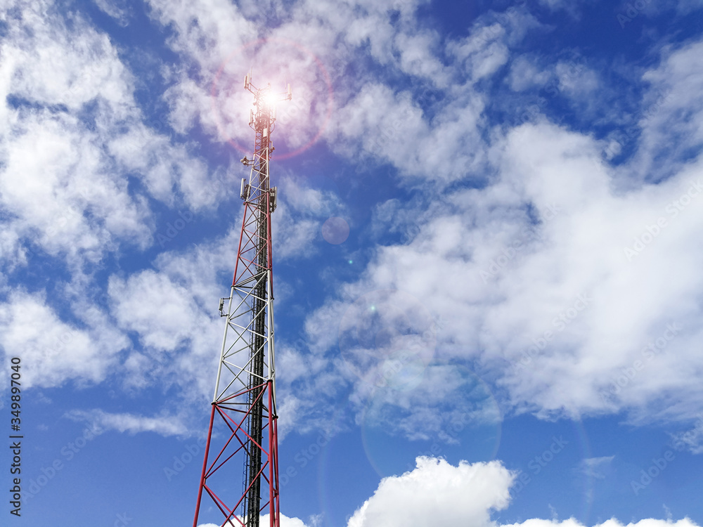 GSM repeater tower in front of blue cloudy sky GSM repeater tower in front of blue cloudy sky