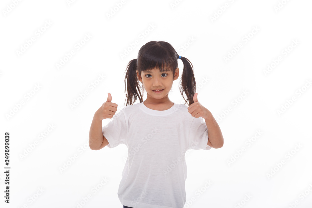 Little asian girl wearing mask for protect pm2.5 and show thumbs up gesture for good air outdoor.Air pollution pm2.5 and Coronavirus concept Little asian girl wearing mask for protect pm2.5 and show thumbs up gesture for good air outdoor.Air pollution pm2.5 and Coronavirus concept