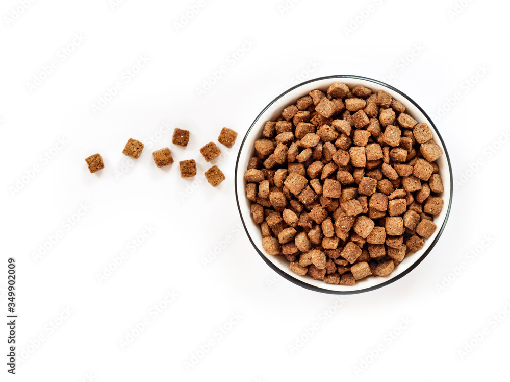 Dry pet food in a white ceramic bowl isolated on white background. Flat lay, top view. Copy space Dry pet food in a white ceramic bowl isolated on white background. Flat lay, top view. Copy space