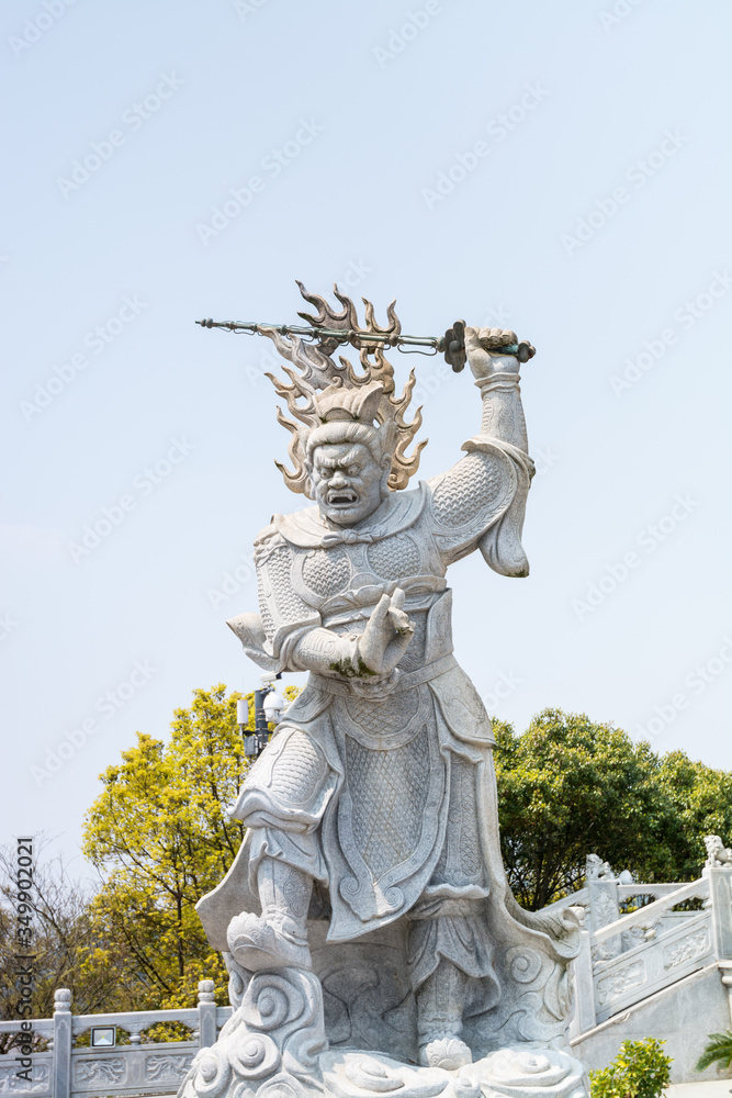 Statue of the Viruḍhaka Heavenly King in front of Golden statue of bodhisattva guanyin Mount Luojia, Zhoushan, Zhejiang, the place where Bodhisattva Guanyin practiced Buddhism