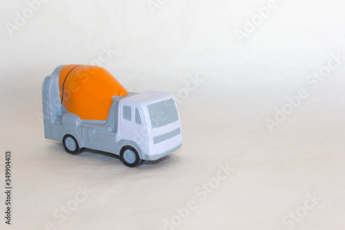 layout of concrete truck mixer on rough white-grey background. Free copy space. Delivery of ready mix concrete on job-site. Concept of concrete transportation, construction.