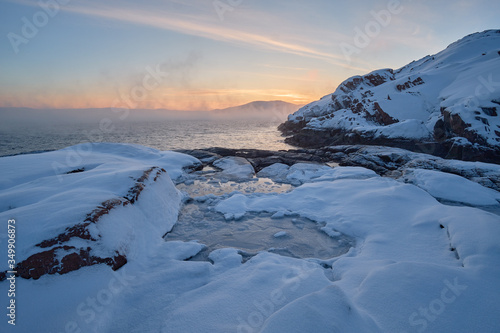 Winter arctic landscape in the morning on the Barents Sea with fog from frost