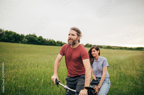 Romantic couple riding bicycle together 