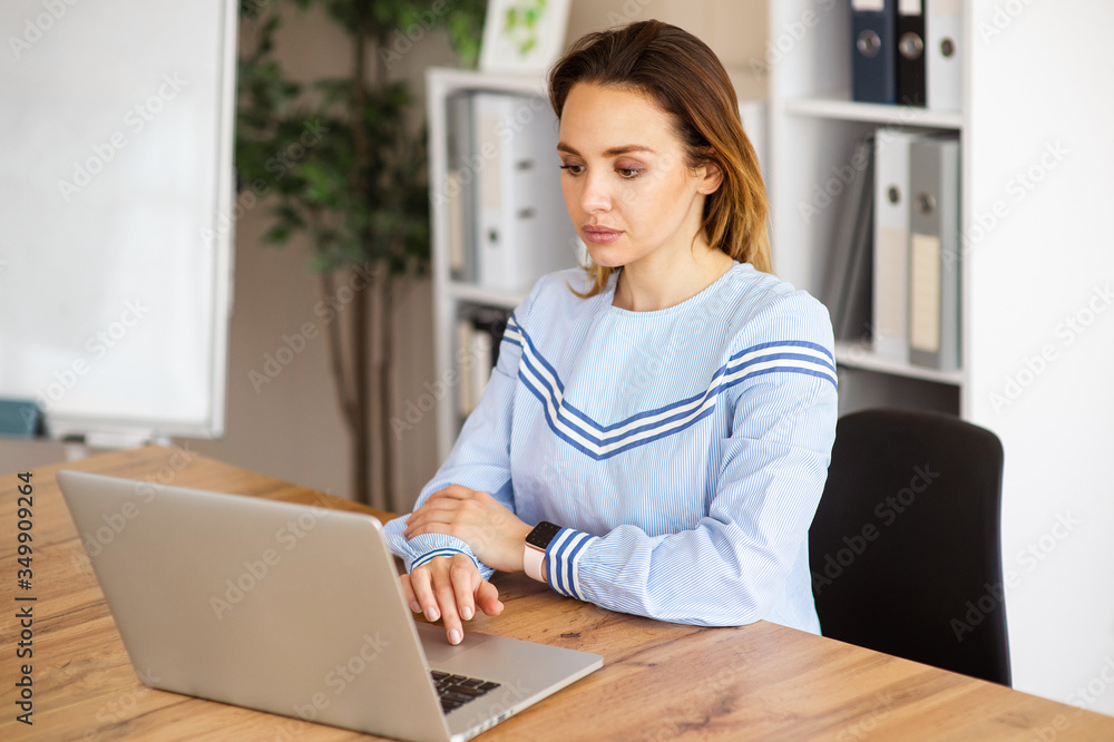 Portrait of business woman working with laptop in office Portrait of business woman working with laptop in office