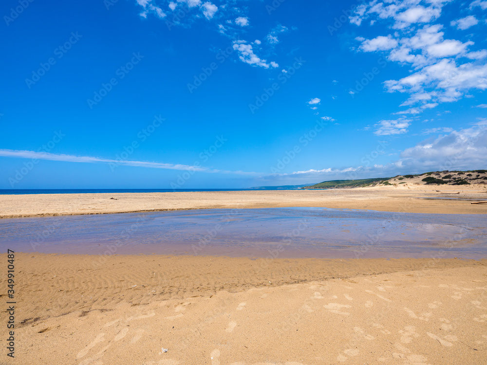 The immense and wonderful beach of Piscinas with its exotic panorama, near imposing and sinuous dunes of fine, warm golden sand