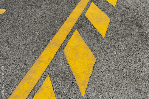 Yellow road sign on asphalt. Road marking, symbol for parking area, stripe and rhombus elements