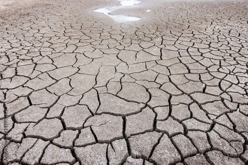 dry cracked ground  with puddle of water