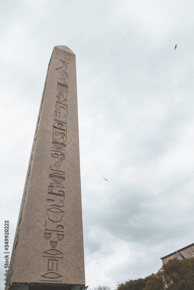 The Obelisk of Theodosius in Sultanahmet Square in Istanbul. Obelisk of Theodosius close-up in gloomy weather. Egyptian hieroglyphics on a large obelisk