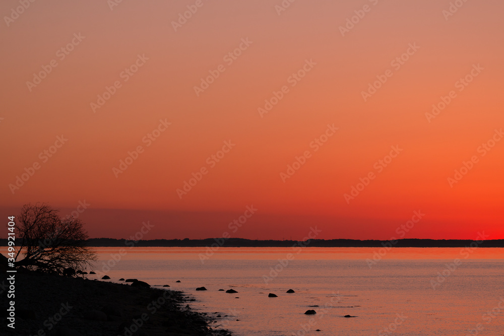 seascape with coastline and red evening sky